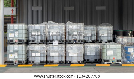 Plastic IBC Tank stack on each other inside chemical storage area for storing liquid chemical use in Oil field drilling operations.