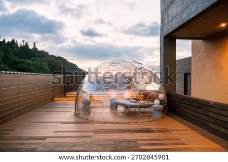 Plastic igloo dome tent on hotel rooftop at sunset, Kumamoto, Japan