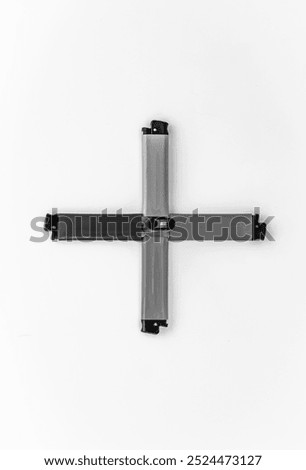 Plastic lighters with mechanical ignition, a compact item for igniting a flame. Black and white horizontal photo from top to bottom.