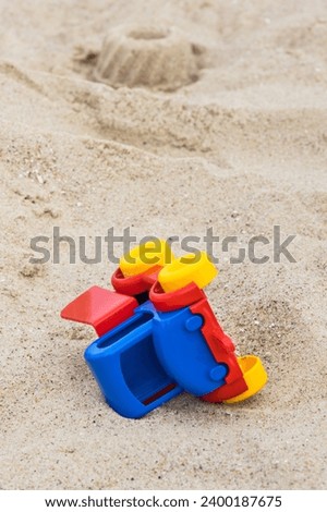 Similar – Sandstrand mit Spiezeugschaufel und Seestern