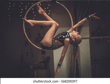 Plastic little girl gymnast on acrobatic ring.