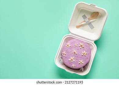 Plastic Lunch Box With Tasty Bento Cake On Turquoise Background