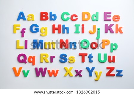 Plastic magnetic letters isolated on white, top view. Alphabetical order