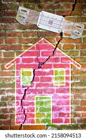 Plastic mechanical crack meter to measure movement across surface cracks and joints - concept with deep crack in a damaged old brick wall cause due to subsidence of foundations structural failures