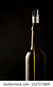 Plastic And Metal Wine Dispenser Inside Wine Bottle On Black Background