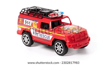 Plastic model fire brigade car isolated on white background. High quality photo