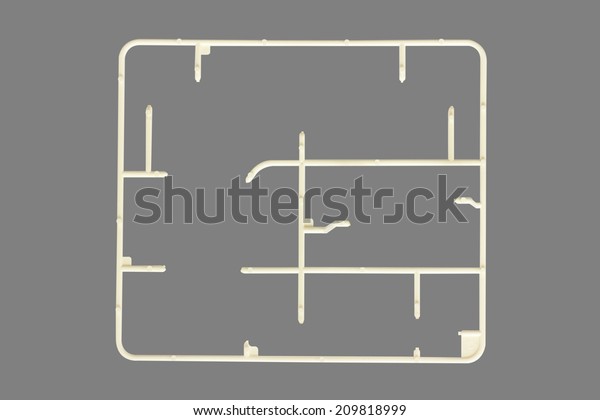 plastic model kits set of toy on a injection molded\
frame with rectangular elements isolated on gray background with\
clipping path