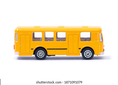 Plastic model of an old yellow bus, toy, miniature isolated on white
