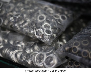 A Plastic Package Containing A Ring For Bag-making Materials, Stored In A Glass Display Case