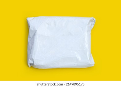 Plastic Parcel Bag On Yellow Background.