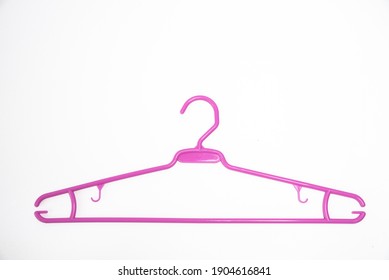 Plastic Pink Clothes Hanger On White Background.