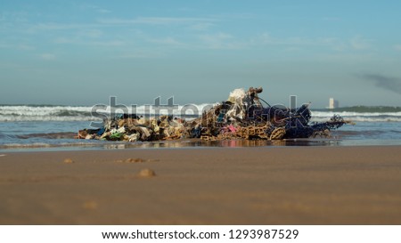 Plastic Polution showing discarded plastics and fishing nets and latex rubber on East Atlantic Beaches, Morocco , Africa, Sky save our oceans