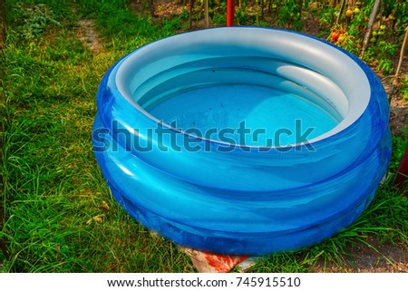 Plastic pool in a summer day outdoors.