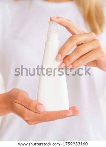Plastic pump triangular bottle for a gel or mousse. Feminine hands hold White clean jar with space for your logo. Vertical front view cosmetic mockup