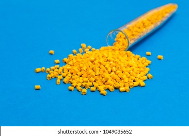 Plastic raw materials in granules for industry.Yellow Polymer on a blue background. Plastic granules after processing of waste polyethylene and polypropylene.Polymer. BPA FREE.Plastic pellets . 