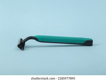 Plastic Razor On A Blue Background.