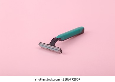 Plastic Razor On Pink Background.