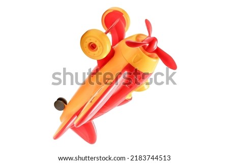 It is the plastic red airplane with a propeller and wheels .It's a red and yellow plane. It is the children's plastic aircraft without a shadow on a white background.  