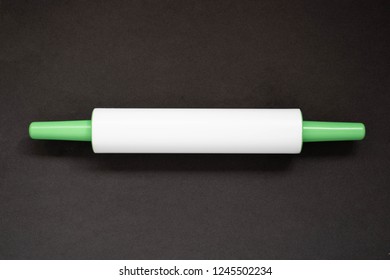 Plastic Rolling Pin On A Black Background