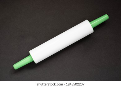 Plastic Rolling Pin On A Black Background