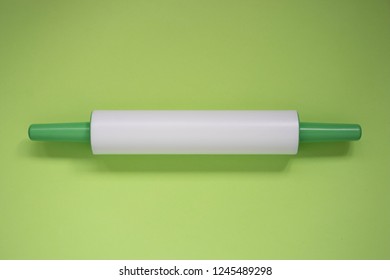 Plastic Rolling Pin On A Green Background