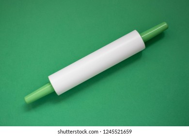 Plastic Rolling Pin On A Green Background