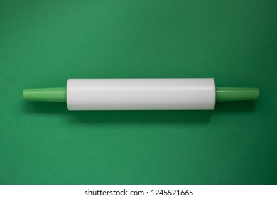 Plastic Rolling Pin On A Green Background