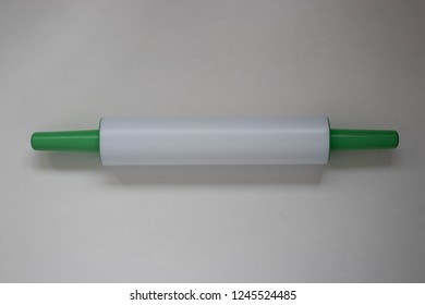 Plastic Rolling Pin On A White Background