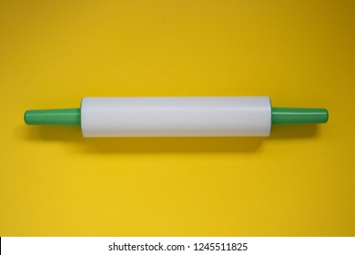 Plastic Rolling Pin On A Yellow Background