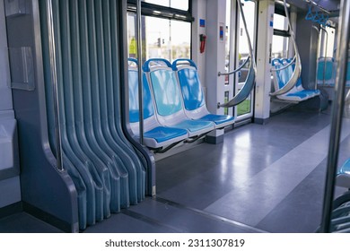 Plastic seat backs in an empty interior of a city tram. Inside view