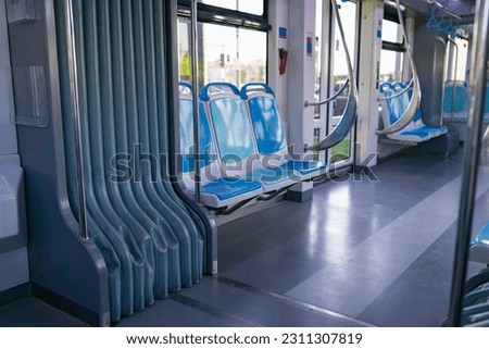 Plastic seat backs in an empty interior of a city tram. Inside view