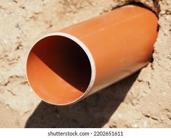 Plastic Sewer Pipe In The Ground. Installation Of Water Main, Sanitary Sewer, Storm Drain Systems