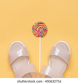 Plastic Shoes With Sweet On Yellow Background