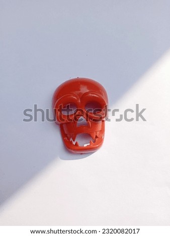 Plastic skull toy put on the paper photo.