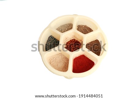 Plastic spice Indian masala box. In an Indian kitchen spice box with most commonly used spices like garam masala coriander, turmeric, red chilly and cumin powder.