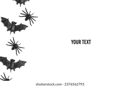 Plastic spiders with bats on white background. Halloween decor. Top view. Copy space - Powered by Shutterstock