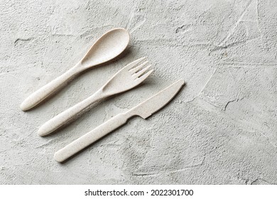 Plastic Spoon, Fork And Knife Left On Concrete Background