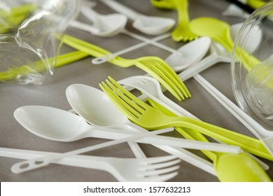 plastic spoons, forks and cups, Single use, Disposable tableware, Plastic pollution, waste, eco, ecology, recycle. Plastic processing problem