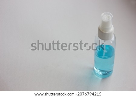 Plastic spray bottle contained alcohol cleaning for sanitizer and virus protection, isolated on dity table background.