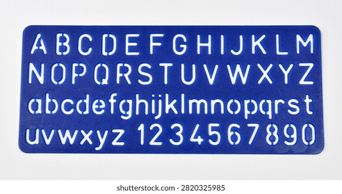 Plastic stencil sheet used for tracing uppercase letters, lowercase letters, and numbers
