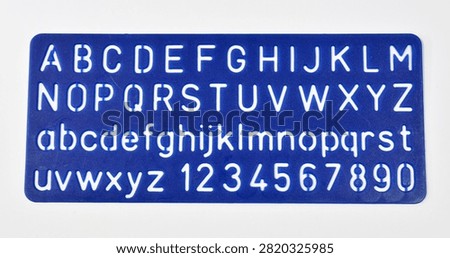 Plastic stencil sheet used for tracing uppercase letters, lowercase letters, and numbers