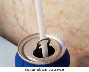 Plastic Straw Held In Metal Pull Tab Of Blue Soda Can