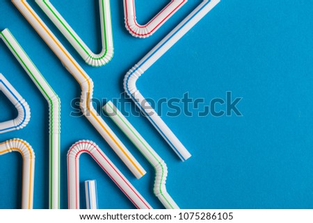 Plastic straws on a blue background