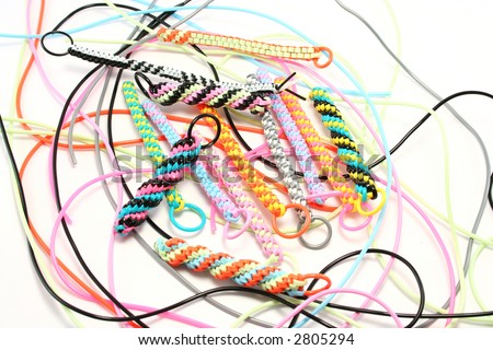 Plastic strings used to make scoubies (boondoggles in USA). Recent craze in UK to make zip pulls, keyfobs etc