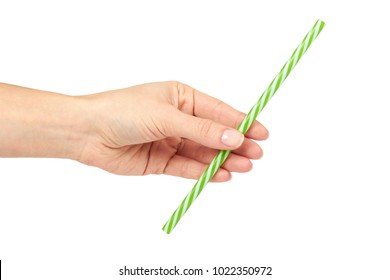 Plastic striped green straw in hand, isolated on white background.