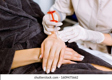 A Plastic Surgeon Doctor Does An Injection Of A Beauty Injection Into The Hands Of Young Woman. Hand Wrinkle Rejuvenation Concept, Close-up. Lipofilling