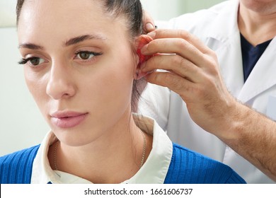 Plastic Surgeon Examines Ear Of Patient Before Plastic Surgery