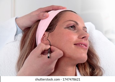 Plastic Surgeon Marking Woman’s Face