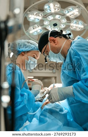 plastic surgeon performs surgery in the operating room