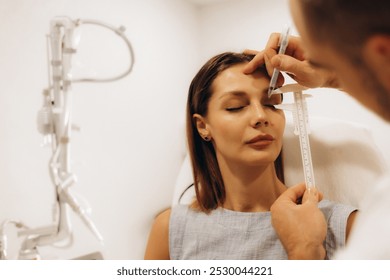 Plastic surgeon preparing for operation on woman face - Powered by Shutterstock